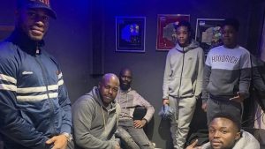 wayne with young boys in a recording studio