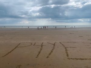 p4ye name written in sand on the beach